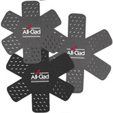 All-Clad pot protectors in star pattern protecting cookware from scratches during storage.