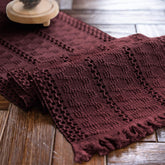 Alynsehom burgundy macrame table runner with tassels enhances dining ambiance.