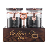 Artiform coffee storage jar with wooden stand keeps beans visible and organized.