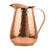 Artisan's Anvil hammered copper pitcher front view with handle for elegant entertaining.