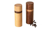 Artistic India oak salt shaker with moisture-absorbing interior for smooth seasoning.