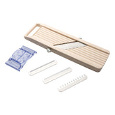 Benriner mandoline body and blades for precise cuts.