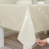 Benson Mills heavy-duty crystal-clear 70x90 tablecloth on dining table protects surfaces while showing wood grain