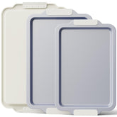 BRONYPRO ceramic baking sheet set in cream with non-stick surface for easy cookie release.