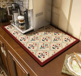 Cciphy coffee-maker mat on counter protects surfaces from spills.