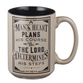 Christian Art Gifts Mans Heart Mug front view with Proverbs 16:9 for daily inspiration.