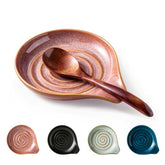 Cormomu spoon rest with swirl red glaze on a counter, keeping utensils tidy.
