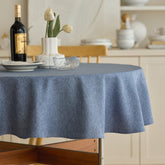 Decorelia denim blue round tablecloth on a 70-inch table protecting from spills