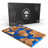 Designium olive wood resin cutting board close-up showing dense grain for longevity.