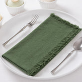 DeZerlor olive green napkins with fringe on rustic wedding table decor