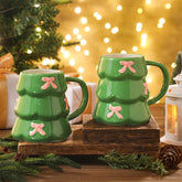 Didaey Christmas tree mug in green ceramic with pink bow, perfect for cozy cocoa.