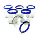 Dos Sueños hand-blown glass set with cobalt blue rims for elegant table setting.
