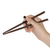 Edison Friends training chopsticks for adults show right-handed grip with silicone rings for beginners.
