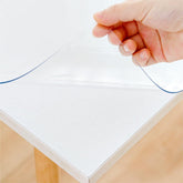 Eisdroma clear table cover on dining table protecting from spills and scratches.