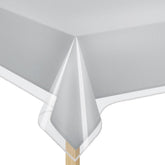 Elaine Karen crystal-clear table cover protecting linens from spills and showing design.