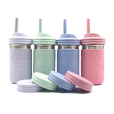 Elk and Friends 14oz mason jar with sleeve and lid for durable on-the-go sipping.