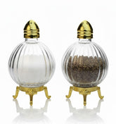 Fairturk globe-design salt shaker with ribbed glass body enhances table elegance.