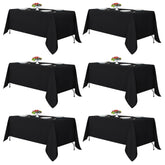 Fitable black tablecloth rectangle 6-pack stacked for easy setup and elegance.