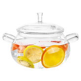 Generic glass cooking pot with lid on stove for even heating of soups.