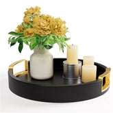 HB Design Co round decorative tray in black with gold handles on a coffee table