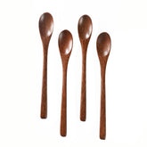 Hefild padauk wooden spoon shown with honey pot for precise jar scooping.