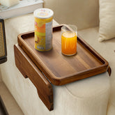 HOLANA Acacia Wood Sofa Armrest Tray securely attached to wide sofa arm for stable snacking
