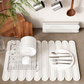 Imgrose stone drying mat on a counter showing rapid water absorption for dishes.