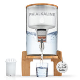 Invigorated Water glass alkaline dispenser on counter for clean hydration.