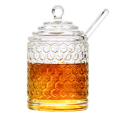 Iyulania glass honey jar with lid and dipper for mess-free serving.