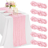 JALANCY pink cheesecloth table runner adds romantic ambiance to weddings.