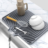JIUBAR dish drying mat by the sink with drain spout keeps water away from counters.