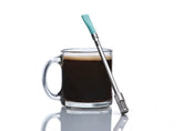JoGo portable coffee straw in hand, showcasing compact travel-ready design.