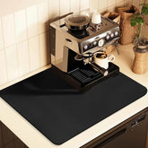 JuSiyley coffee mat under a coffee maker protects counters from spills and stains.