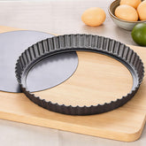KUAYB 10-inch tart pan with removable bottom for effortless tart release after cooling.