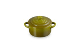 Le Creuset mini cocotte in olive glaze, close-up of premium stoneware finish.