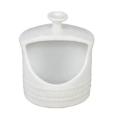 Le Creuset salt crock with side-opening for easy salt access during cooking.