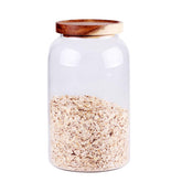 Leaves and Trees Y large glass canisters with airtight lids, organized pantry storage.