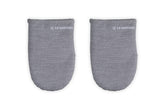 Le Creuset mini oven mitts grip hot handles securely for safe oven transfers.