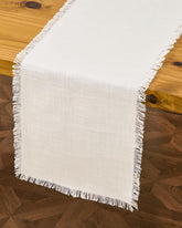 Letjolt white table runner on a casual table setting adds relaxed elegance.