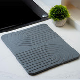 LIFSEZY stone drying mat on counter absorbs moisture quickly for fast-drying dishes.