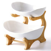Liywall two-tier ceramic fruit bowl on bamboo stand for stylish countertop storage.