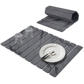 Lprmnnc diatomaceous-earth dish mat folded on counter for space-saving storage.