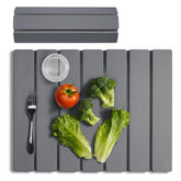 Meowoo Stone Drying Mat laid flat on counter with dishes drying.