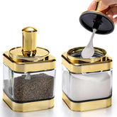Mezchi 2-pack glass condiment pots with clear bodies for easy spice visibility.