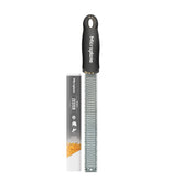 Microplane Premium Classic Zester zesting lemon for bright citrus notes in dressings.