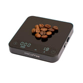 MiiCoffee Minipress palm-size scale beside a compact espresso machine for precise dosing