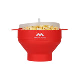 Mindful Design collapsible red popcorn popper in use for quick, mess-free snacks.