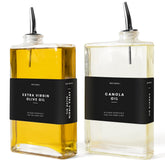 Molimoli olive oil dispenser set with twin glass bottles and black pourers for precise pouring.