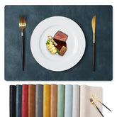 MOSAYT navy blue vinyl placemats protecting table from heat and spills.