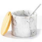 NHKRTE marble salt cellar with lid and spoon on counter for easy seasoning.